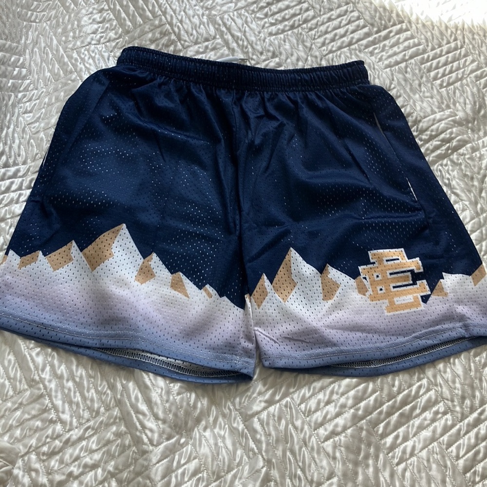 Black and white Eric Emanuel shorts with a pair of blue and white Eric Emanuel.